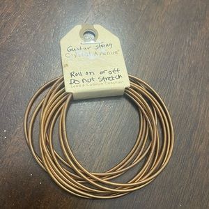 NWT Crystal Avenue guitar string bracelet - coppery gold tone